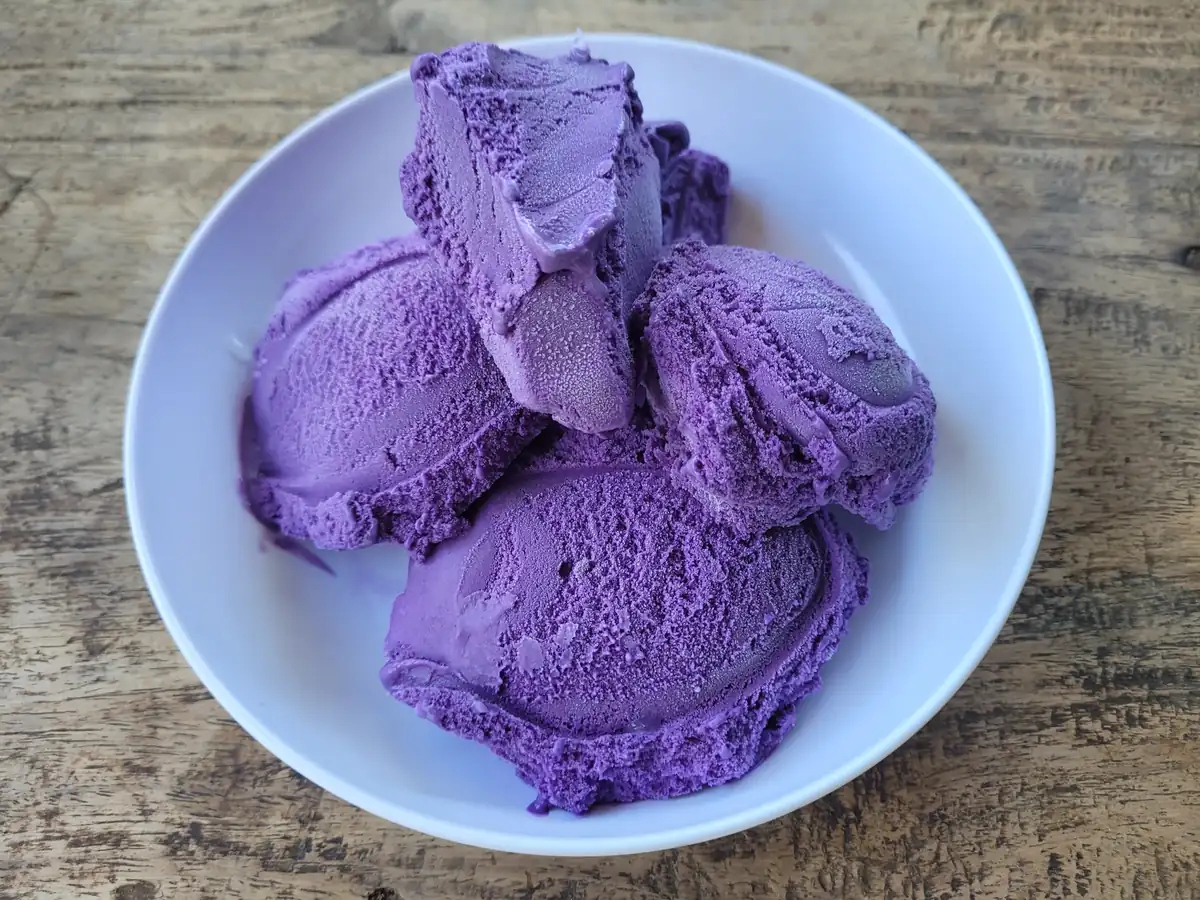 Scoops of purple ube ice cream in a white bowl