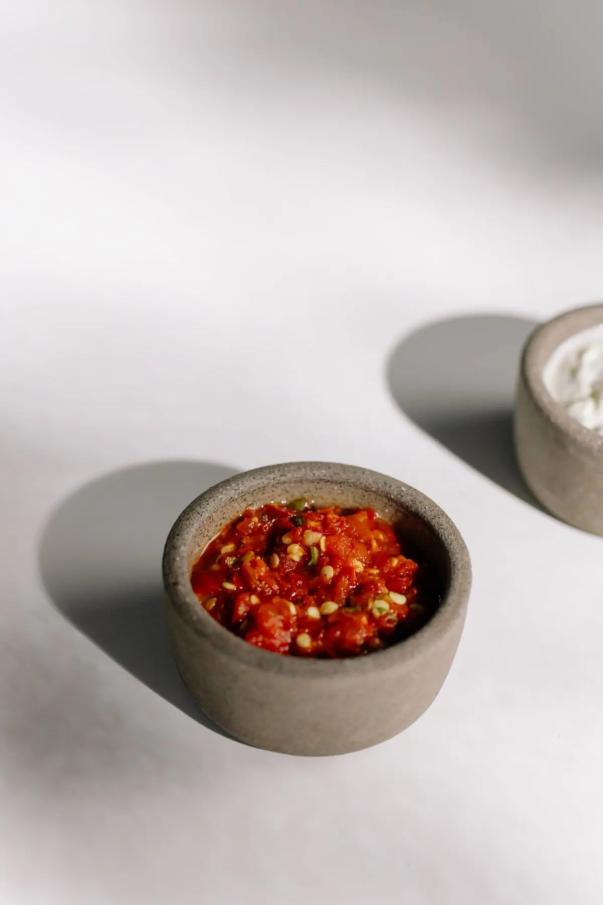 Small bowl of chunky red chili dipping sauce