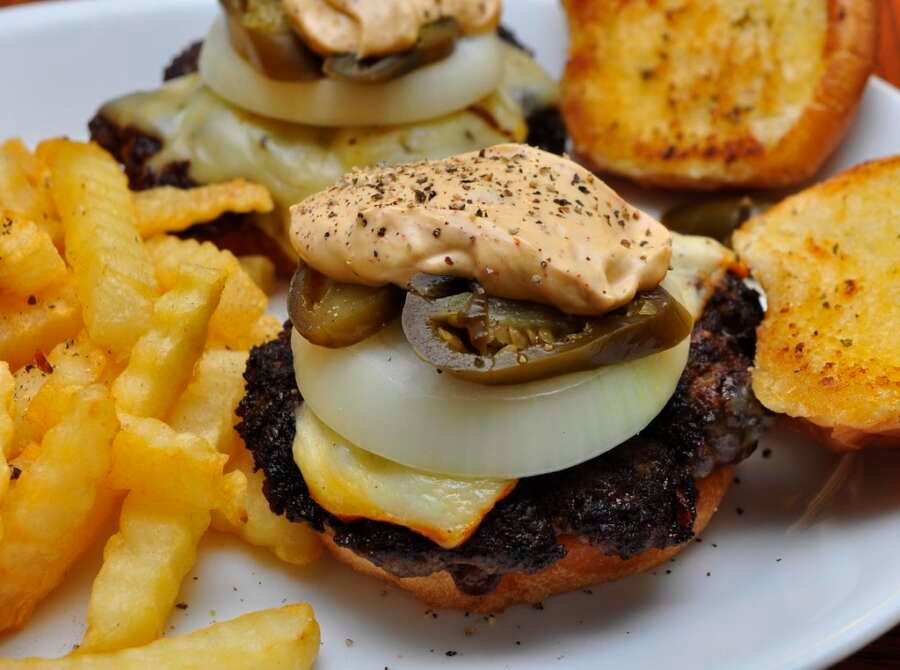 Cheeseburger with melted cheese served with fries