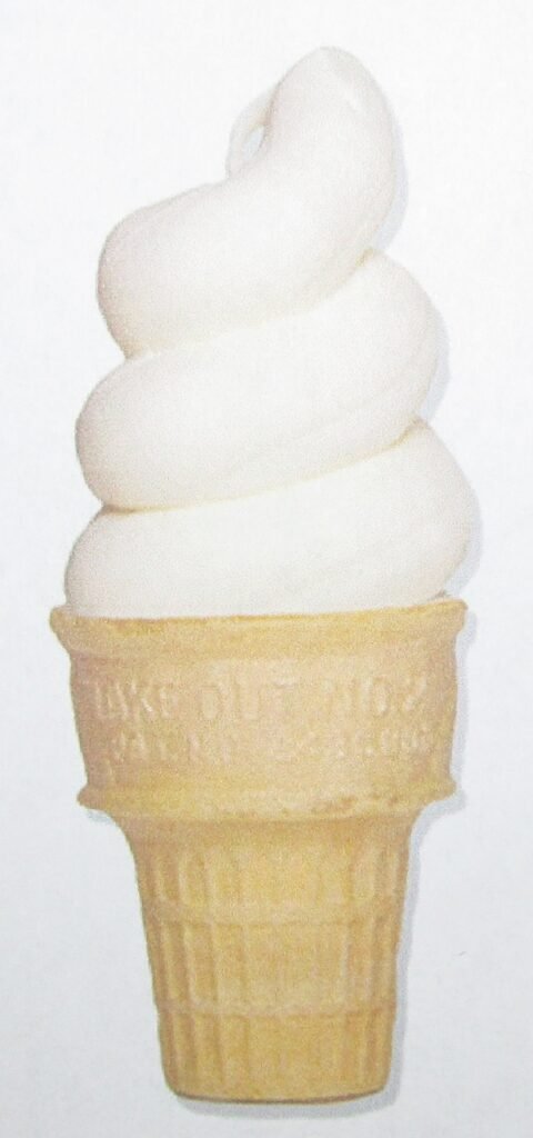 Vanilla soft serve ice cream swirl in a plain wafer cone