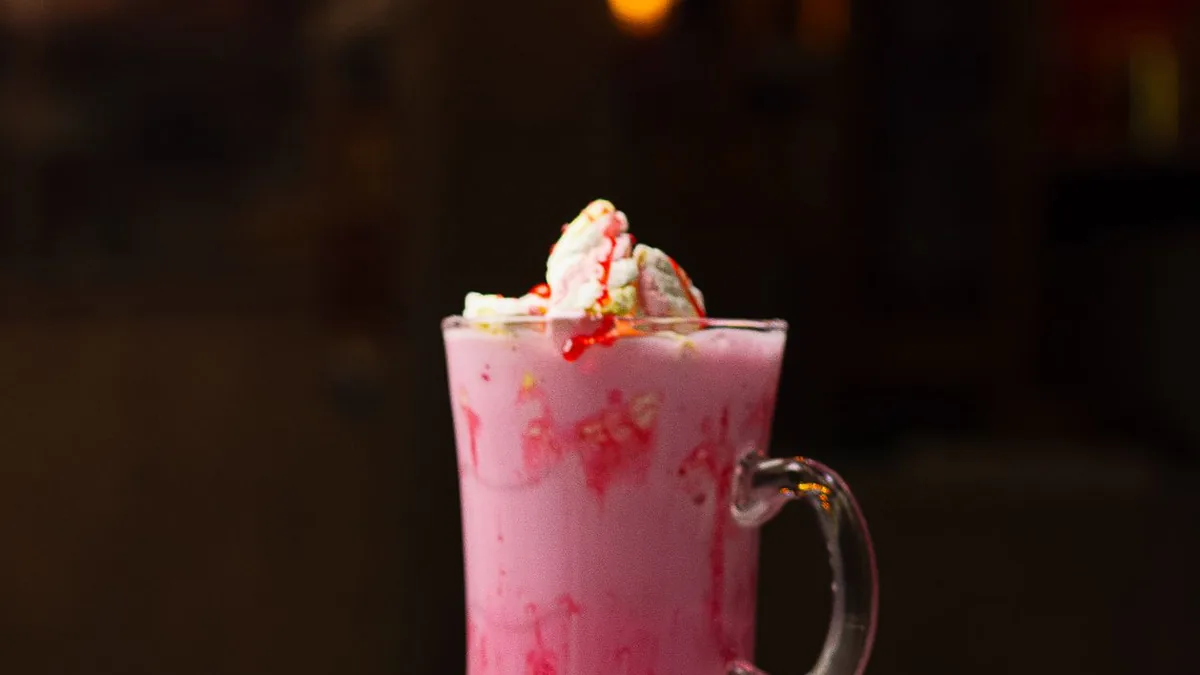 Pink strawberry milkshake with whipped cream